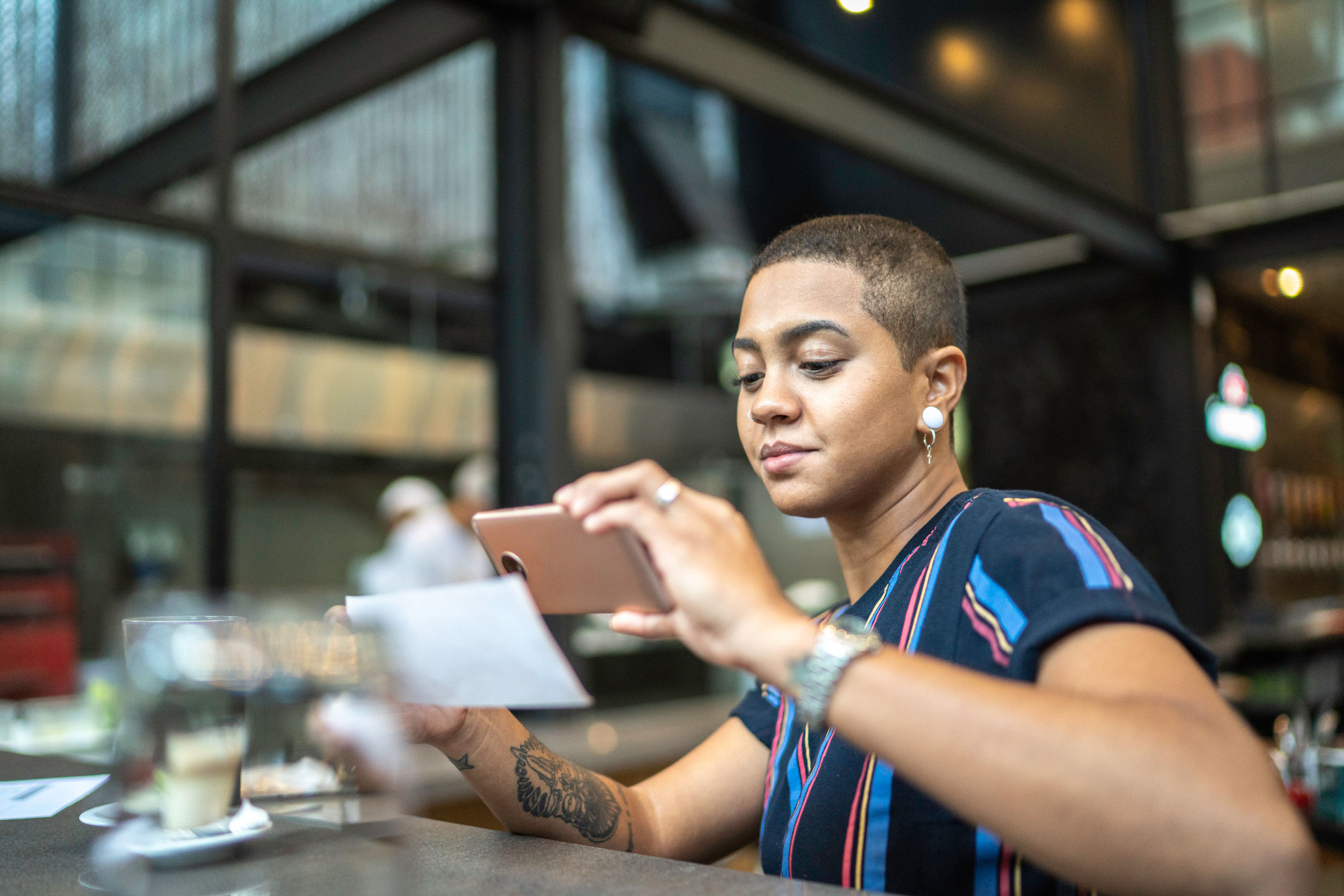 Female taking a picture of her phone to make an online check deposit