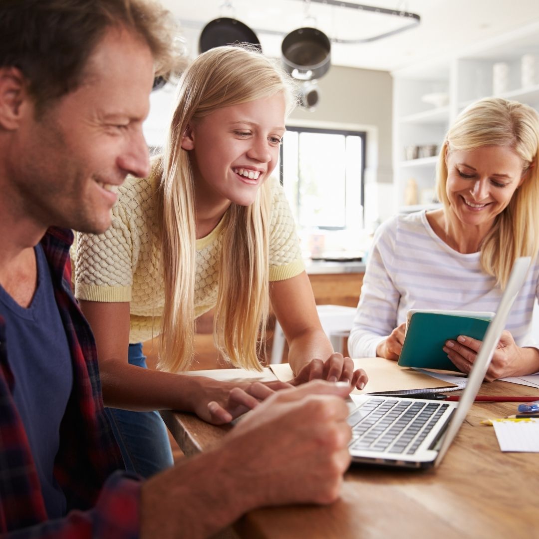 Parents and daughter looking at her teen bank account on a computer
