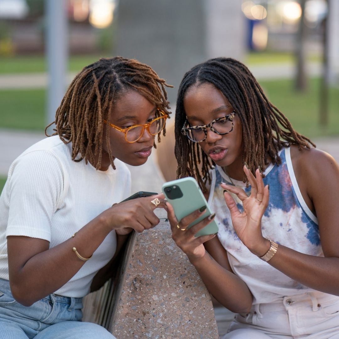 Two young females looking at a mobile phone