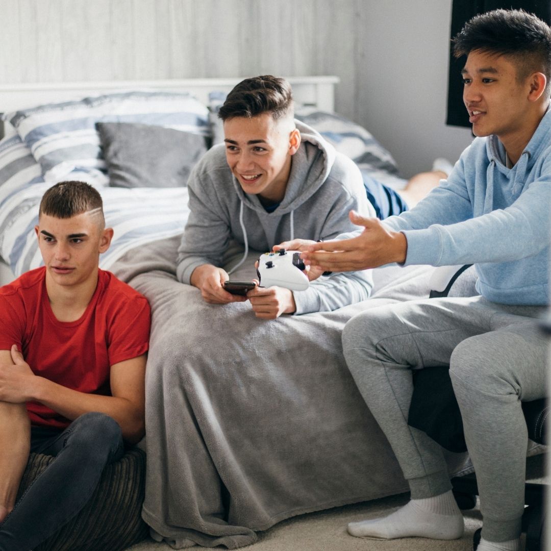 Teen boys playing video games